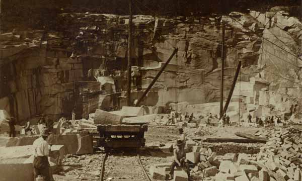 Granite quarries, with derricks, cars, and finished blocks, Concord, New Hampshire